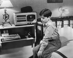 Child listening to vintage radio